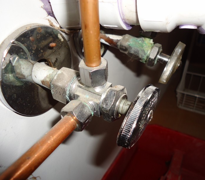 Copper valves and compression fittings on a water service.